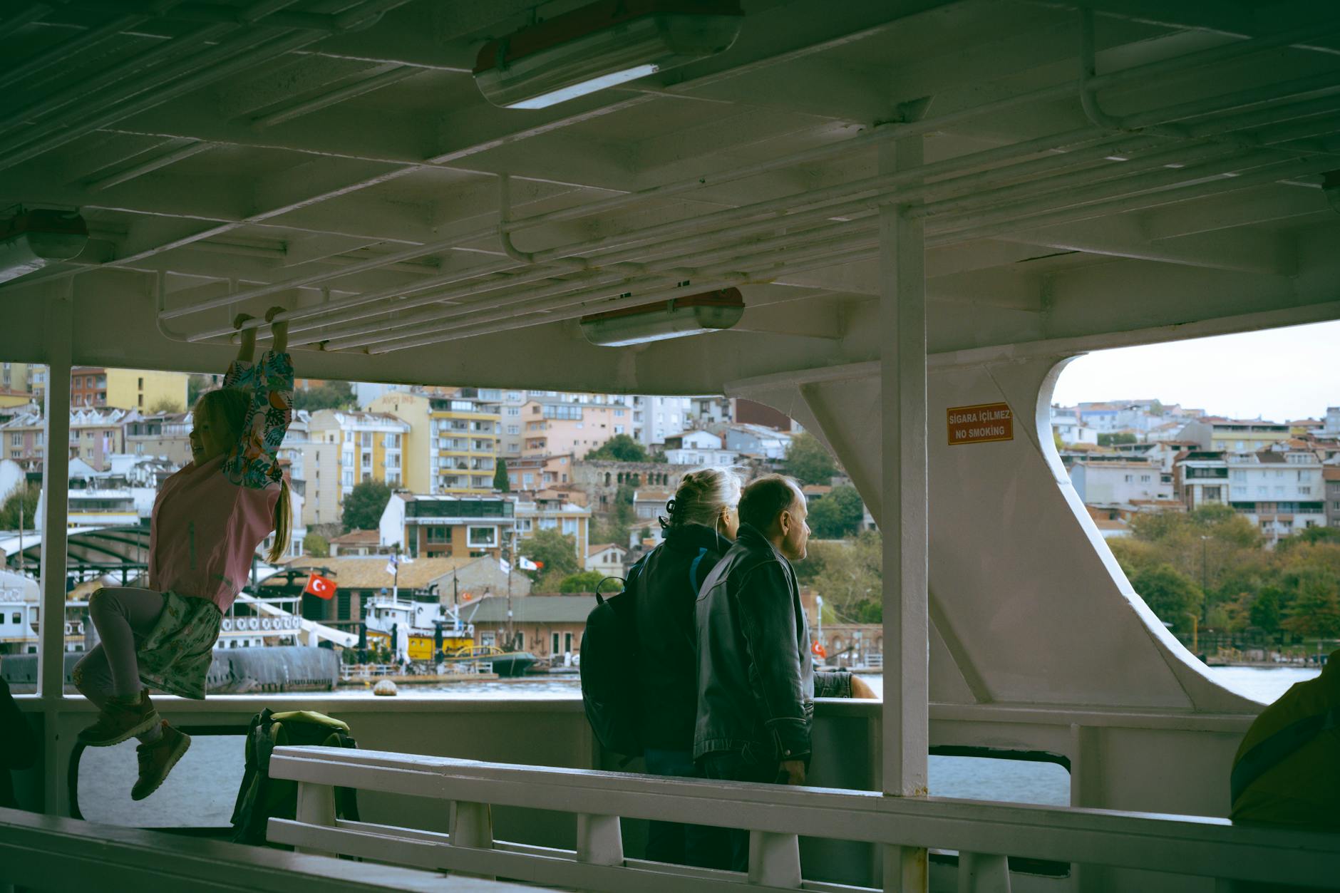 Family riding ferry in Scandinavian harbor in summer