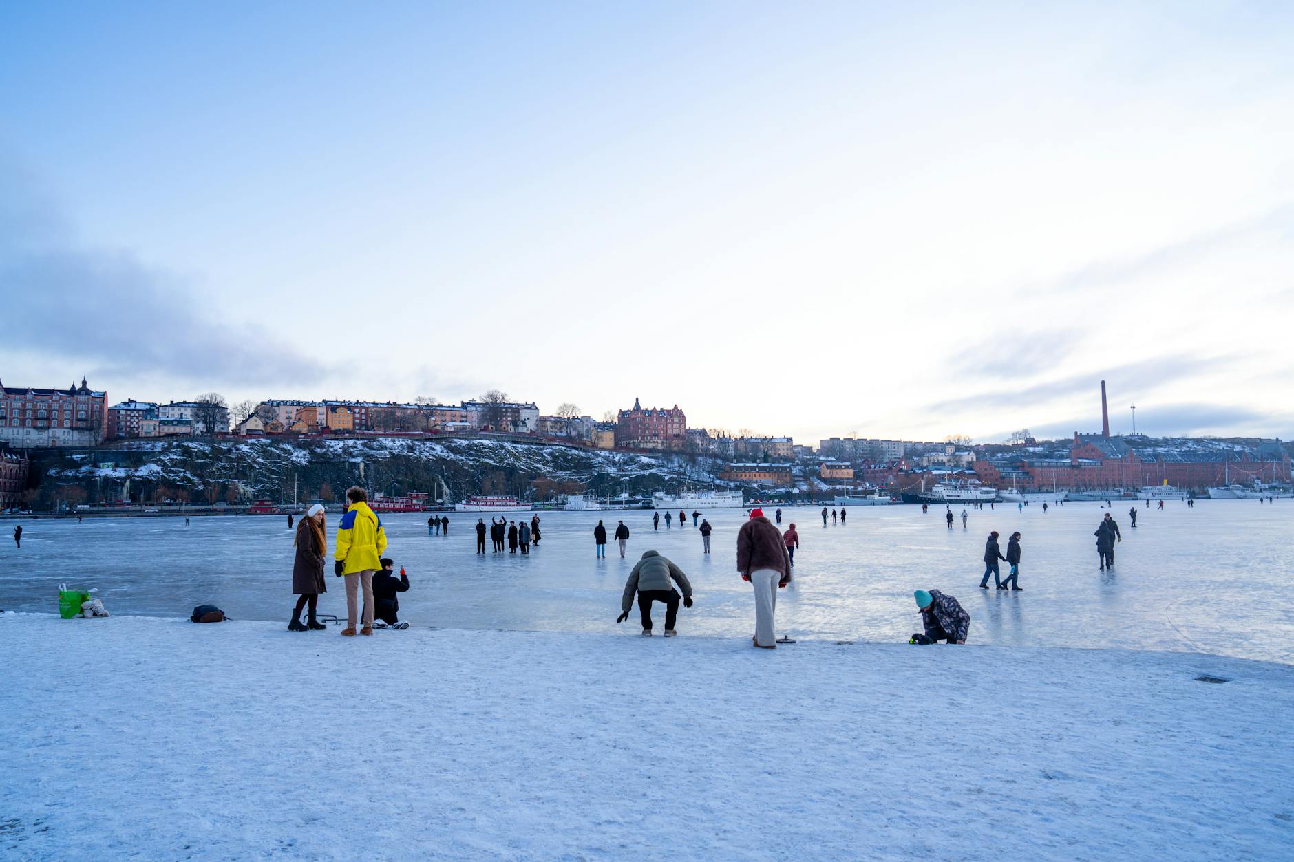 Outdoor ice skating rink in Stockholm with snow-dusted surroundings in winter