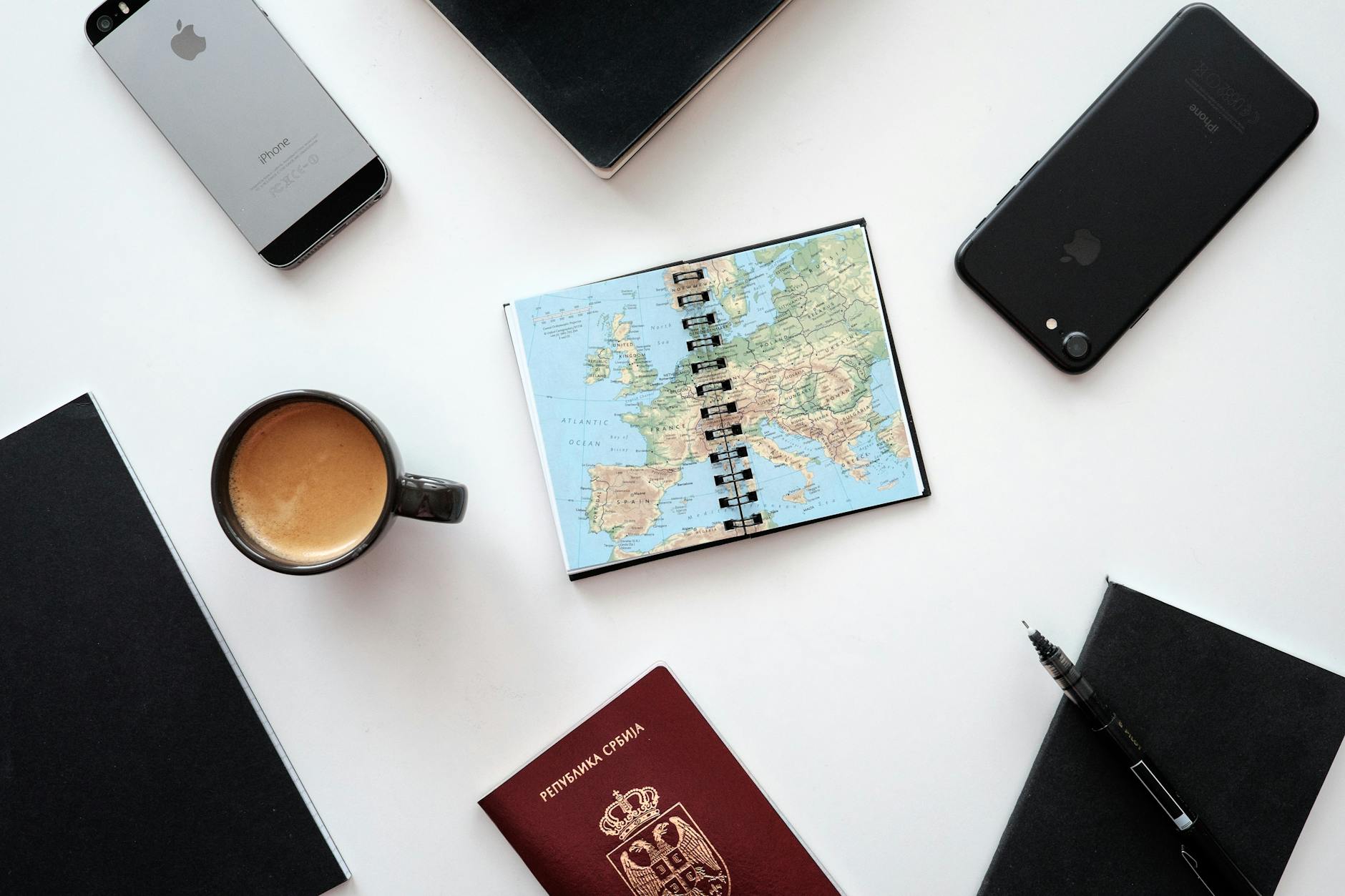 Travel planning notebook with map and coffee
