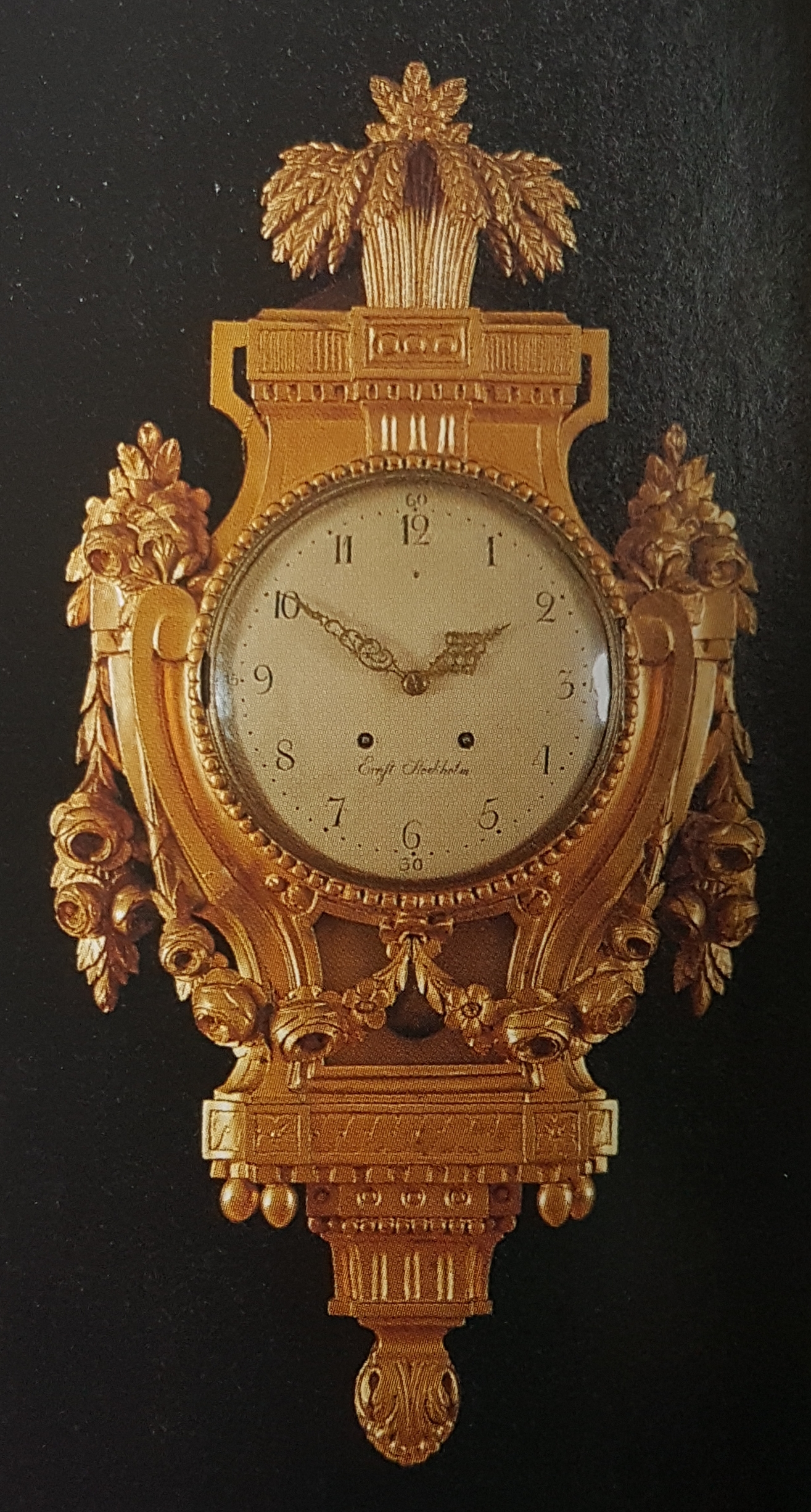 An eighteenth-century gilded Gustavian wall clock with a white enamel dial signed by the Stockholm clockmaker Ernst