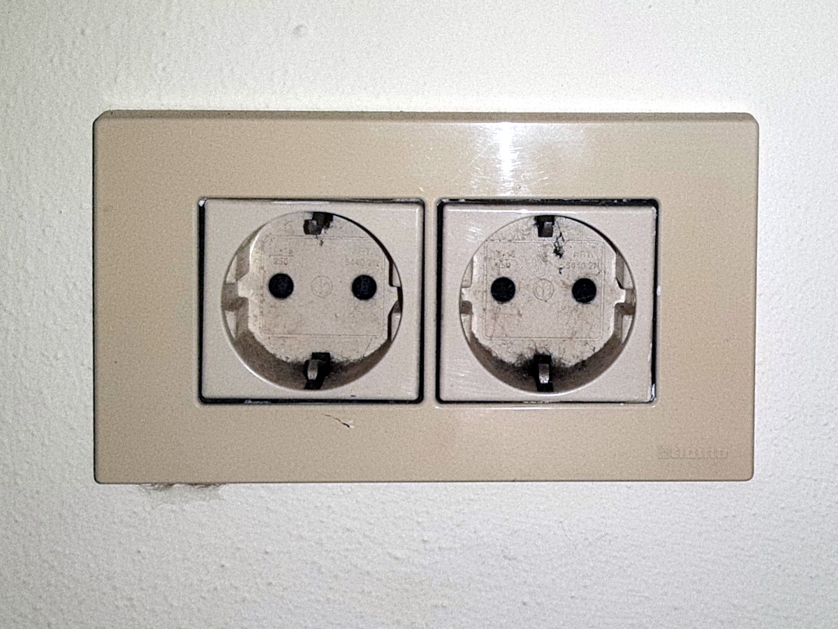 A double Type F Schuko wall socket with two round recessed outlets and side earth clips