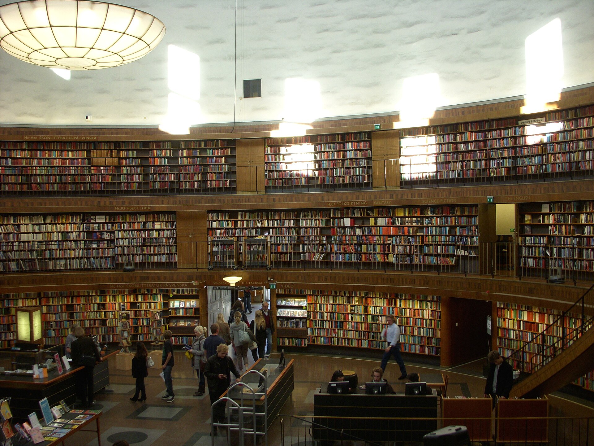 The circular rotunda of Stockholm's public library, Stadsbiblioteket, lined floor to ceiling with bookshelves around a central desk