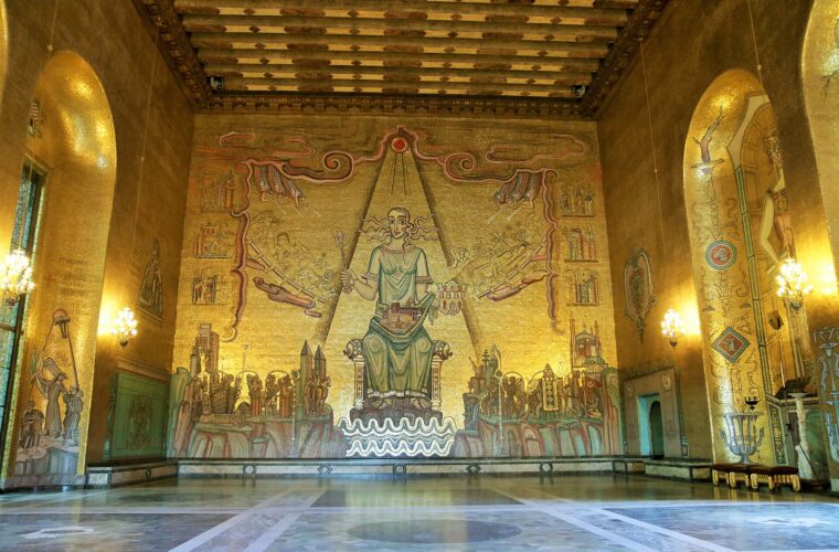 The Golden Hall of Stockholm City Hall, its walls covered in gold mosaic, with the seated Queen of Lake Mälaren on the end wall and a polished stone floor