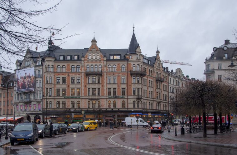 The Stureplan crossroads in Stockholm on a wet grey day, with taxis and turreted corner buildings