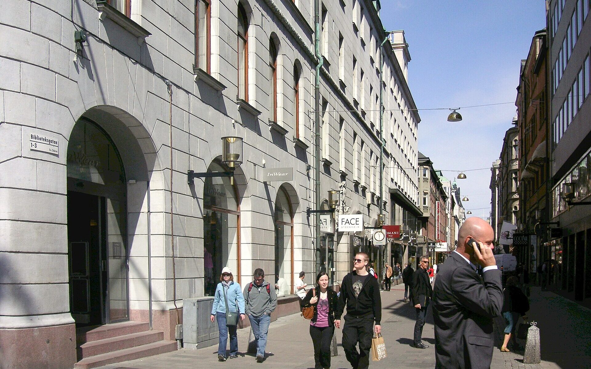 Shoppers walking along Biblioteksgatan, Stockholm's pedestrian luxury shopping street, on a sunny day