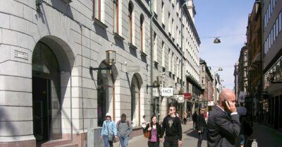 Shoppers walking along Biblioteksgatan, Stockholm's pedestrian luxury shopping street, on a sunny day